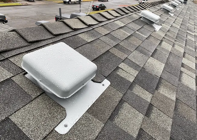 Image of a roof ventilation system on a grey roof